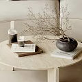 Modern Round Coffee Table With Beige Sofa Side Table Dried Branches Books And Scented Bottle
