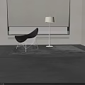 Black Modern Accent Chair In Living Room With Fireplace Flames And Floor Lamp On Rug