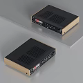 Sleek Compact Black And Gold Audio Amplifier With Control Panel And Ports On Gray Surface