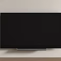 Black TV Wall Mounted on Light Colored Wall With Silver Base and Wooden Floor