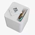 Modern White Trash Bin With Open Top Design Containing Waste and Instruction Manual On Lid