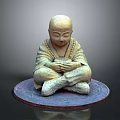 Meditating Man In Traditional Robe Sitting Cross Legged On Circular Mat With Clasped Hands
