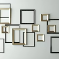 Stylish Assorted Photo Frames In Black And Gold On White Wall