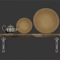Wooden Shelf With Silver Teapot And Two Golden Plates On