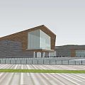 Modern Museum Building Exterior With Sloped Roof Stone Walls And Glass Windows
