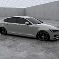 Sleek White Sedan With Black Wheels In Modern Indoor Display Room