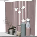 Modern Pink Window Display with Striped Decor Mannequin White Dress Cylindrical Pedestals and Green Plants