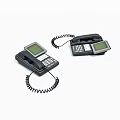 Two Black Landline Telephones With Display Screens Keypads And Coiled Cords