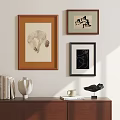 Abstract Paintings Hanging on Wall with Various Frames and Wooden Cabinet Decorative Items