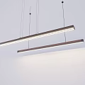 Modern Linear Pendant Lights Hanging In Minimalist Space With Soft Illumination