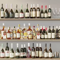 Various Wine Bottles and Glasses Neatly Arranged on Multiple Display Shelves