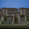 Modern Townhouse Row Exterior With Warm Evening Lighting And Landscaped Front Yard