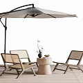 Outdoor Rattan Table And Chair Set With Umbrella On Wooden Deck
