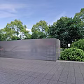 Modern Perforated Metal Fence In Outdoor Area With Green Trees And Paved Surfaces