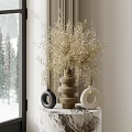 Golden Decorative Flowers in Woven Vase with Black White Vases on Marble Tabletop Snowy View