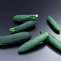Fresh Vibrant Green Cucumbers and Zucchini Vegetables Arranged on Dark Background
