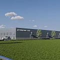 Modern Industrial Factory Building With Gray Exterior Green Lawn Trees Blue Sky And White Clouds