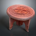 Handcrafted Red Wooden Stool With Round Top Intricate Carved Pattern And Three Legs