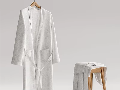 Soft White Long Robe Hanging On Wooden Hanger With Folded Towel On Stool 3d model