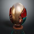 Carved Egg Shaped Sculpture With Golden Body Red Green Accents And Wooden Base