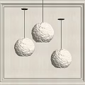 Three White Spherical Pendant Lights With Moon Surface Texture Black Cords And Light Wall Background 3d model
