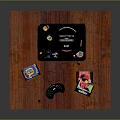 Wooden Tabletop Setup With Black Game Console Controller And Game Discs
