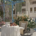 Courtyard Garden With Climbing Vines Flowering Roses Wicker Chair And Decorative Table Setup