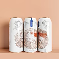 Three Aligned White Beverage Cans With Hand Drawn Mythical Illustrations