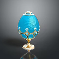 Blue Enamel Egg With Gold Ornaments And Gemstone Accents On Pedestal