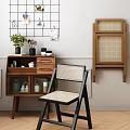 Modern Rattan Accent Chair With Black Frame Wooden Cabinet And Wall Decor