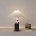 Modern Table Lamp With White Shade And Black Base On Table With Books And Bowl