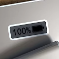 Silver Mobile Power Banks With USB Ports And Digital Displays On Wooden Tabletop