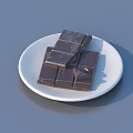 Neatly Stacked Chocolate Pieces of Different Sizes on a White Plate
