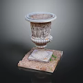 Small Grass Plants In Carved Stone Planter On Square Base With Pebbles