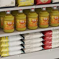 Multi Layered Metal Display Shelves With Various Canned Bottled And Boxed Products