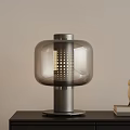 Modern Glass Table Lamp With Gray Metal Base Alarm Clock And Books On Desk