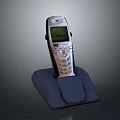 Vintage Mobile Phone On Charging Dock With Illuminated Screen And Classic Numeric Keypad