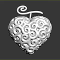 Artistic Silver Heart Shaped Sculpture With Intricate Swirl Carving And Top Curl Design