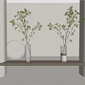 Green Branches in Two Vases on Light Colored Shelf with White Wall Arch Background