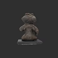 Ancient Stone Sculpture Of Human Figure With Intricate Carvings And Black Base