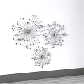 Modern Minimalist Metal Wall Decor With Three Radiant Spiral Pieces on White Wall