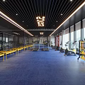 24 Hour Fitness Gym With Blue Carpet Yellow Benches And Workout Equipment