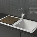 Modern White Kitchen Sink With Wooden Cutting Board And Silver Faucet On Black Countertop