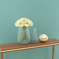 White Flowers in Transparent Vase with Small Golden Vase on Wooden Table Light Blue Background