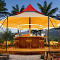 Red Top White Tent With Outdoor Bar And Palm Trees In Natural Setting