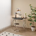 Modern Desk with Curved Metal Legs Dark Tabletop Lamp Photo Frame Vase and Green Plant
