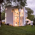 White Modern Vacation Rental Building Surrounded by Trees With Ocean View and Sky