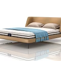 Modern Double Bed With Leather Headboard Light Gray Pillows And Blue Tassel Blanket