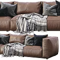 Brown Three Seater Leather Sofa With Gray Black Pillows And Striped Blanket