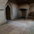 Ancient Interior Featuring Wooden Door Stone Fireplace And Stone Floor Design
